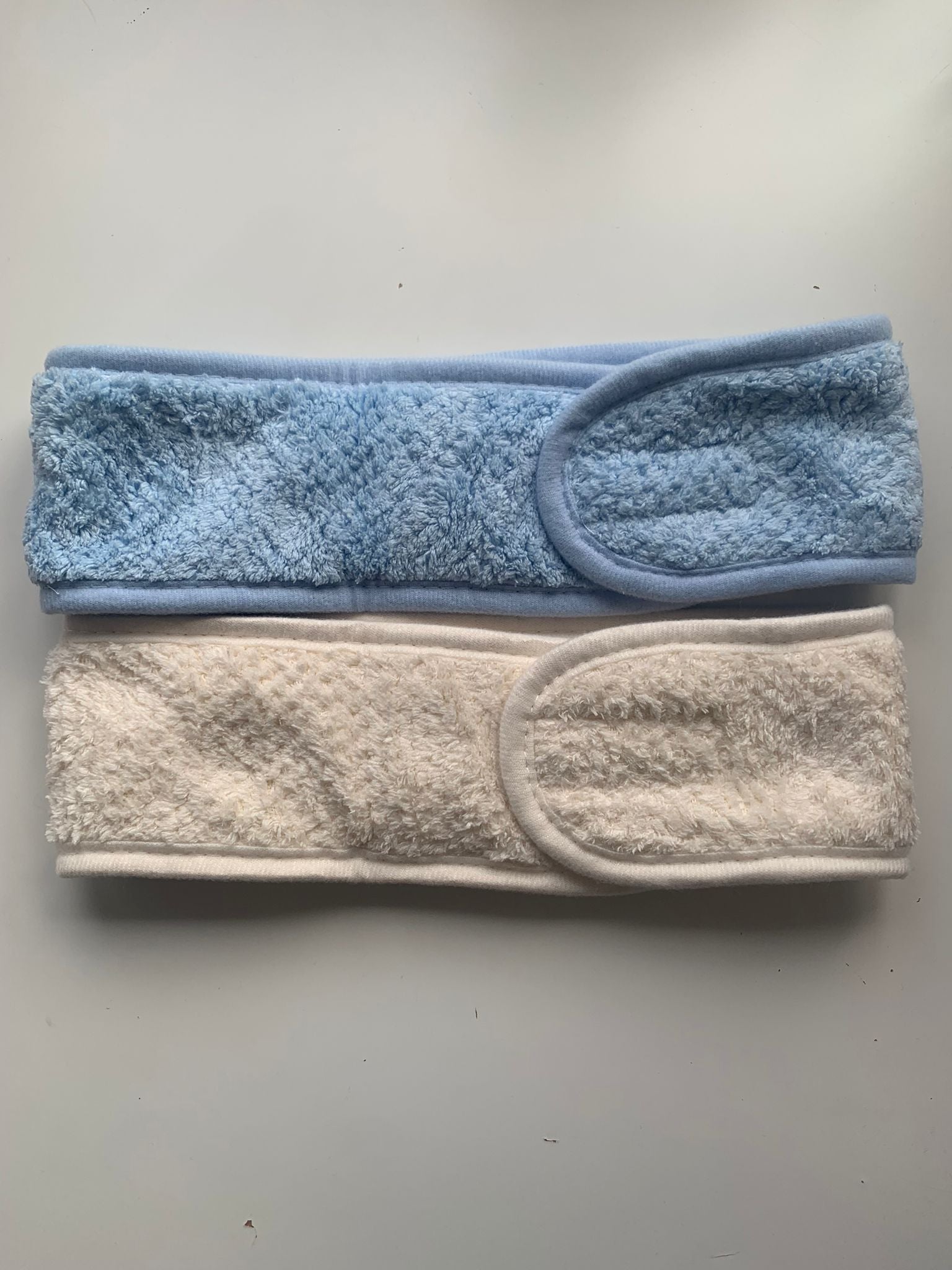 Two soft fabric headbands in blue and cream, ideal for personalised embroidery gifts by Ineedledit.