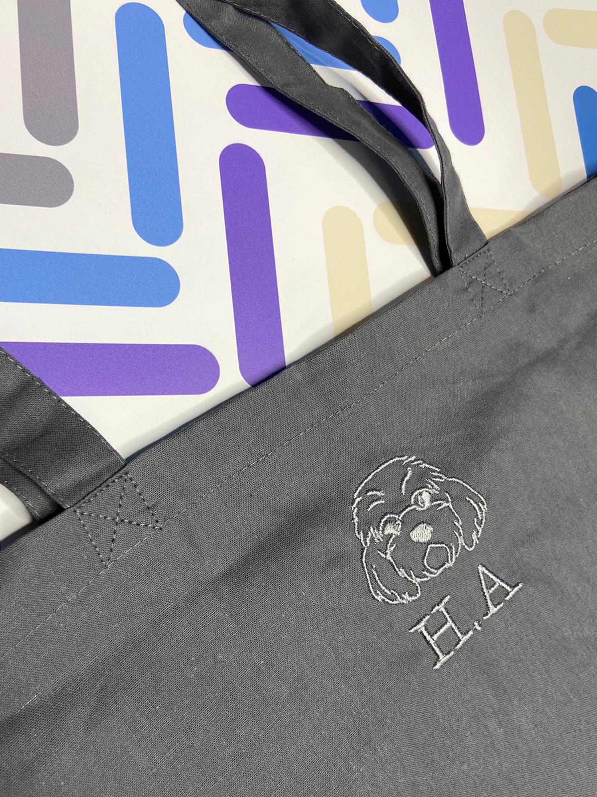 Grey tote bag with personalised dog embroidery and initials H.A, modern background