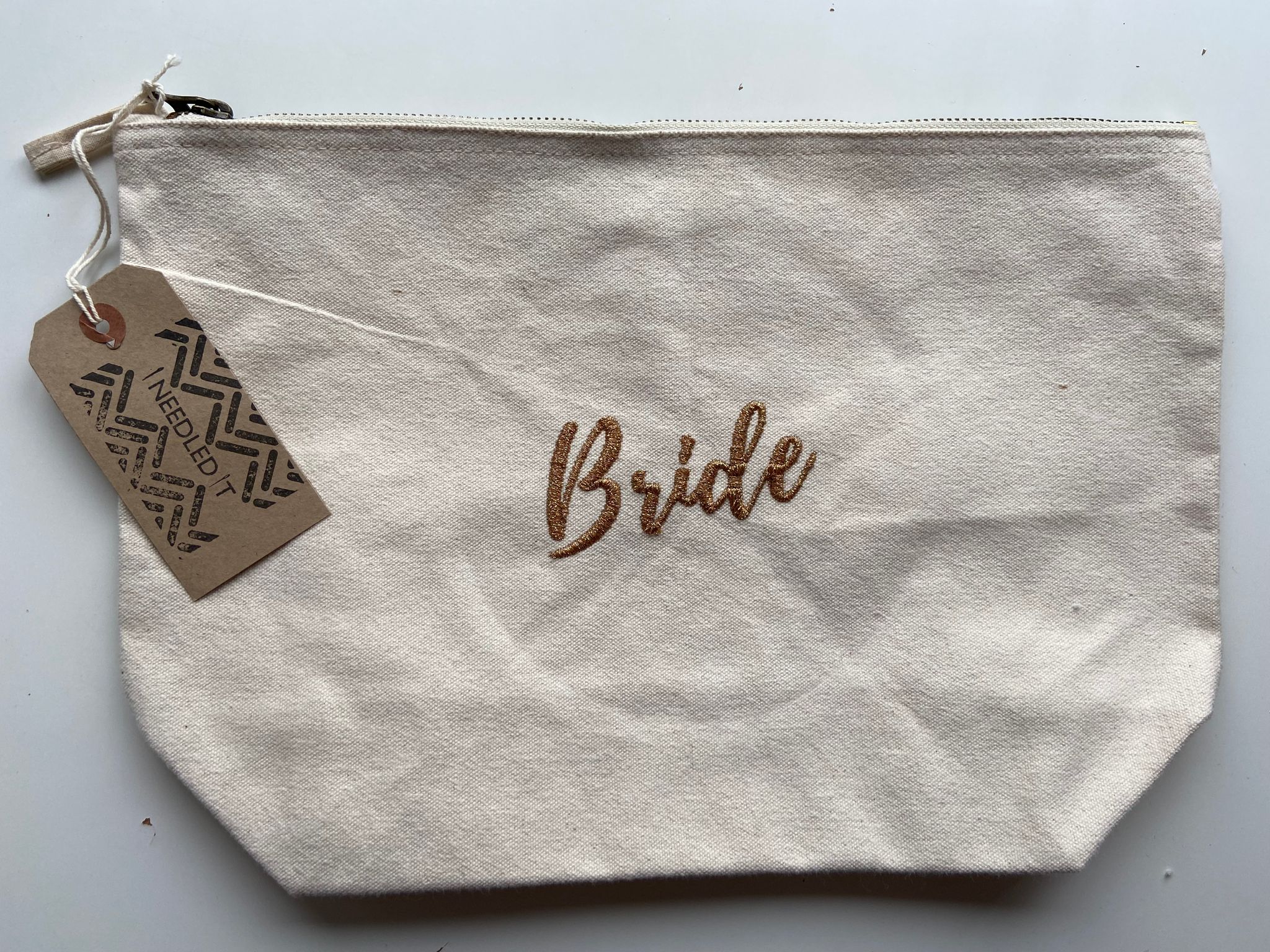 Personalised embroidered Bride pouch by Ineedledit, cream canvas makeup bag with gift tag.