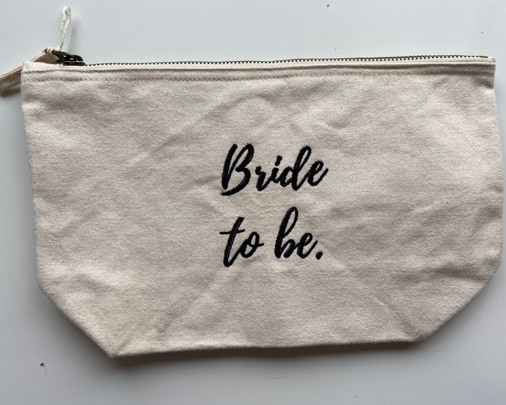 Personalised embroidered makeup pouch with 'Bride to be' text on cream canvas, thoughtful gift