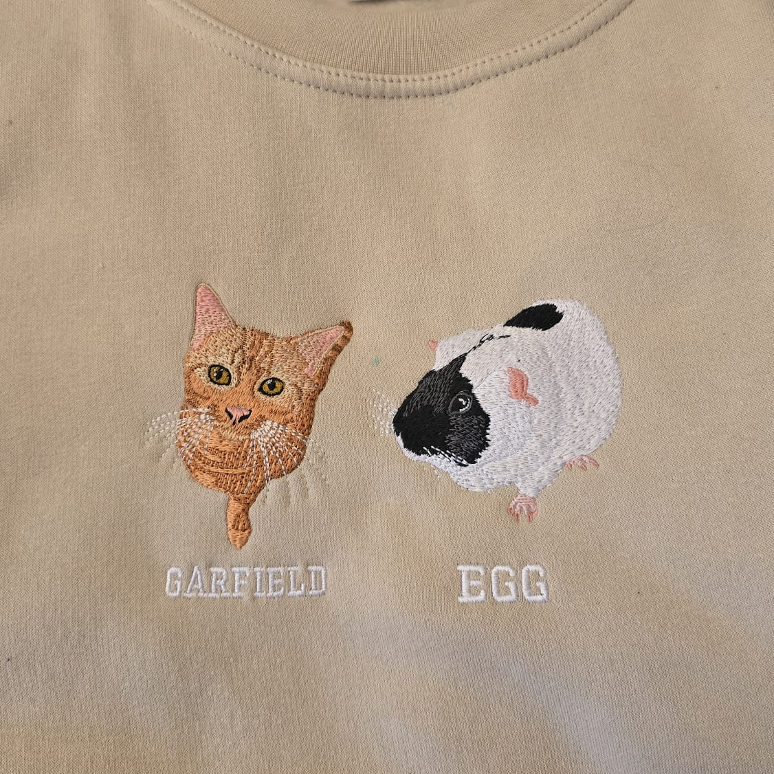 Personalised embroidered cat and guinea pig with names on beige fabric by Ineedledit